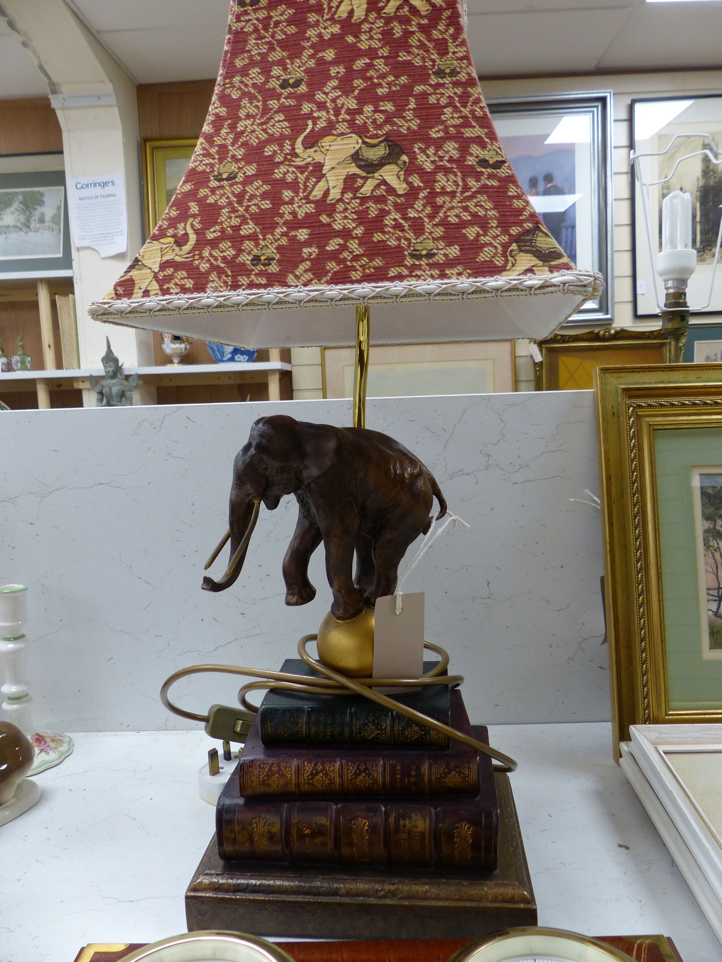 A Wempe wall-mounted ship's style clock/barometer and an 'elephant on books' table lamp